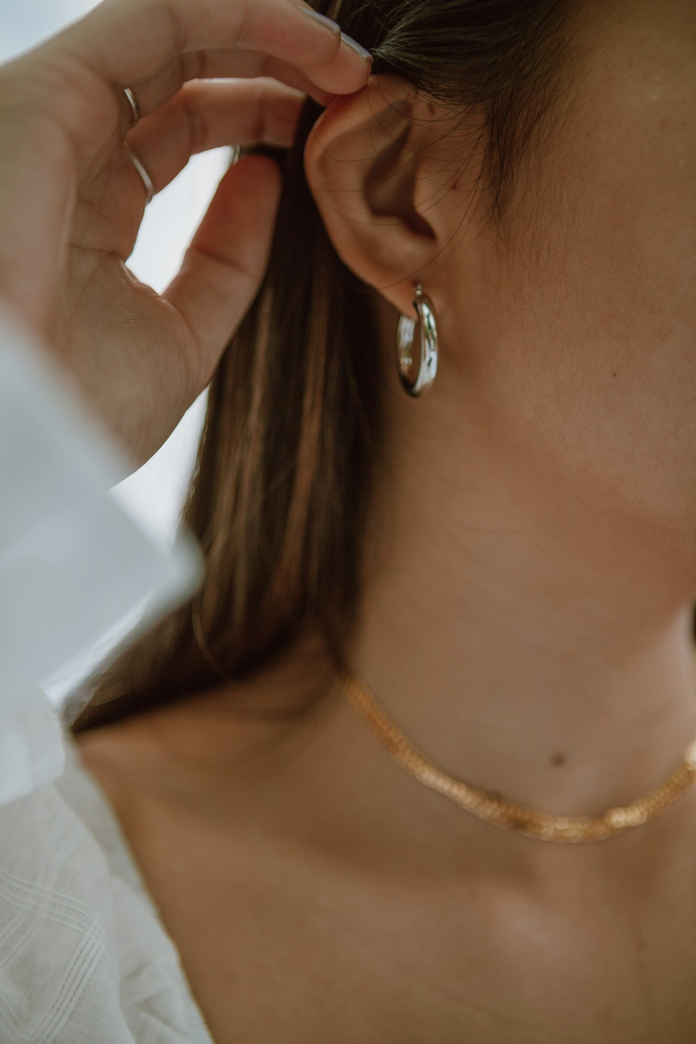 Woman wearing elaborate jewelry with a headwrap